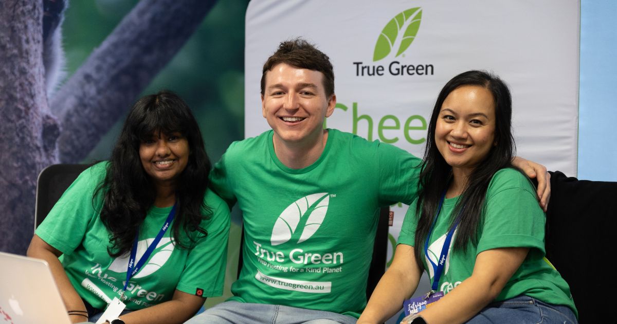 Ray Pastoors smiling with True Green Hosting team members at a marketing event